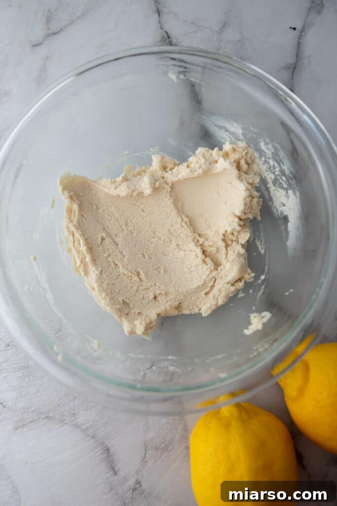 Mixed crust ingredients in a bowl, forming a crumbly dough.