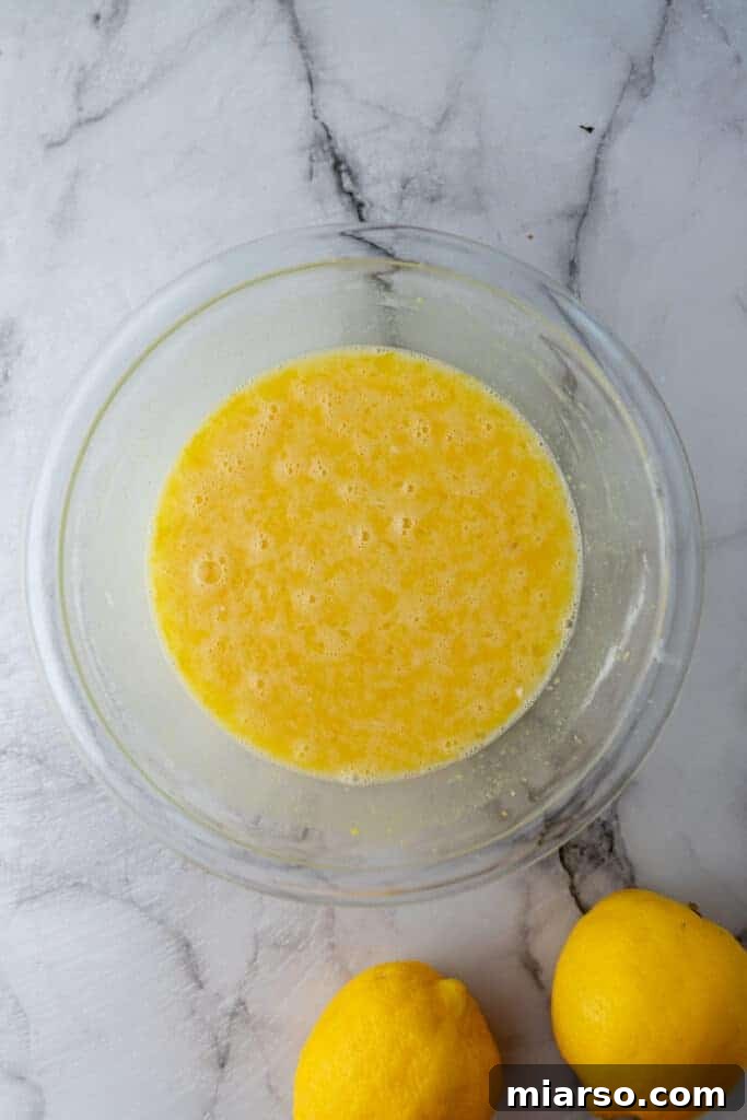 Mixed filling ingredients in a bowl, forming a smooth lemon mixture.