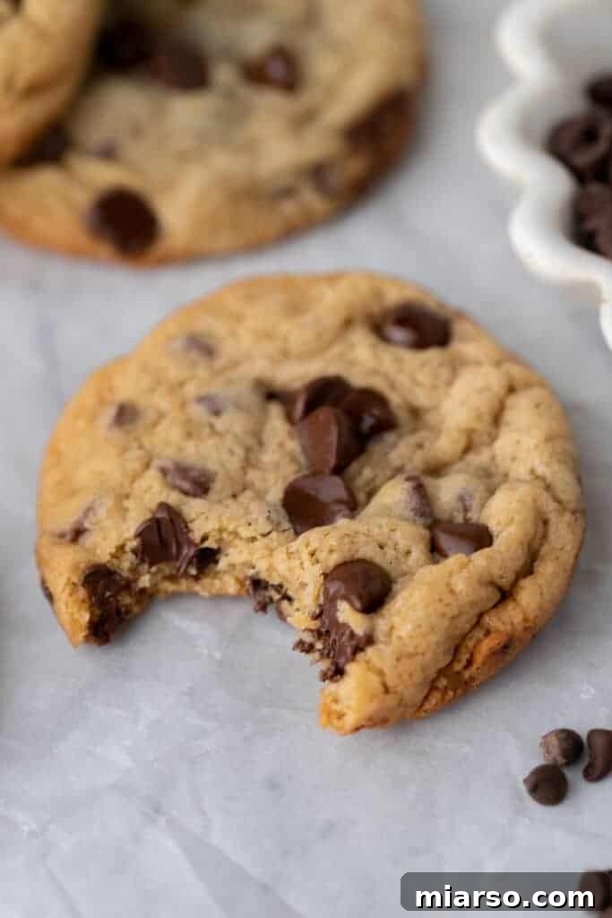 close up of a sourdough discard chocolate chip cookie with a bite taken out