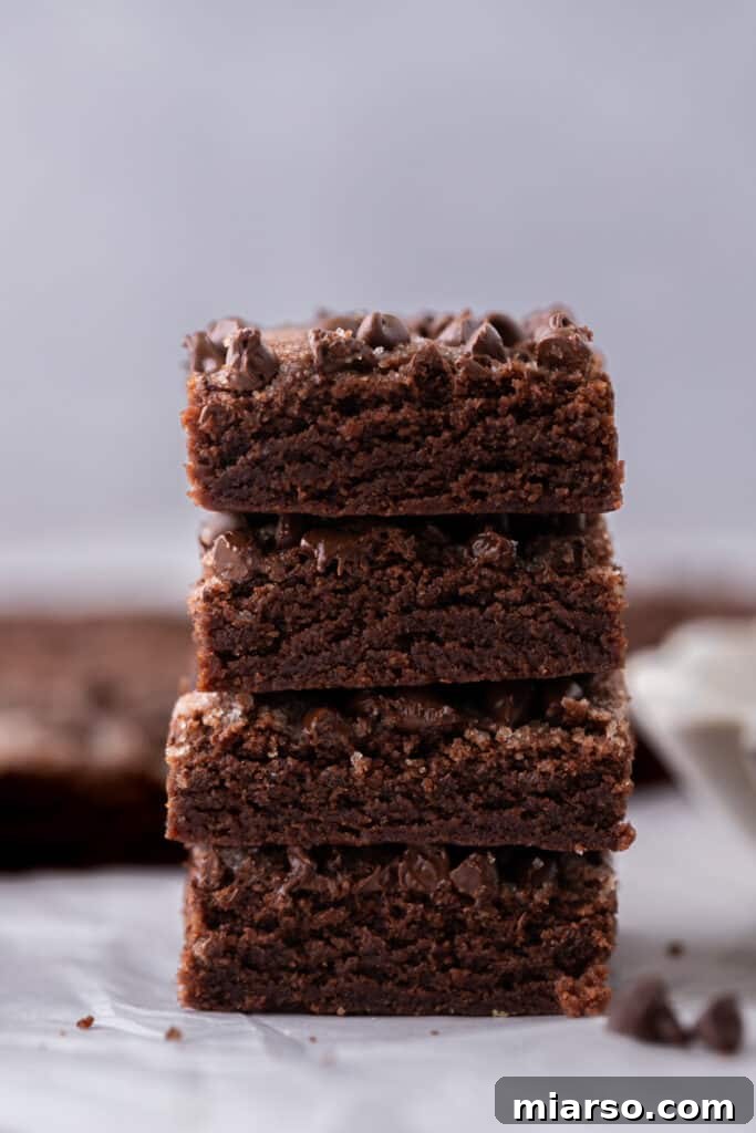 chocolate sugar cookie bars recipe squares stacked on top of each other