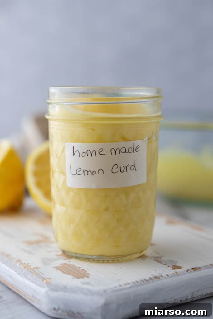 Microwave Magic: Luscious Lemon Curd in Minutes 2 Microwave Lemon Curd Recipe in a jar, showcasing its vibrant yellow color and smooth texture, ready to be enjoyed.