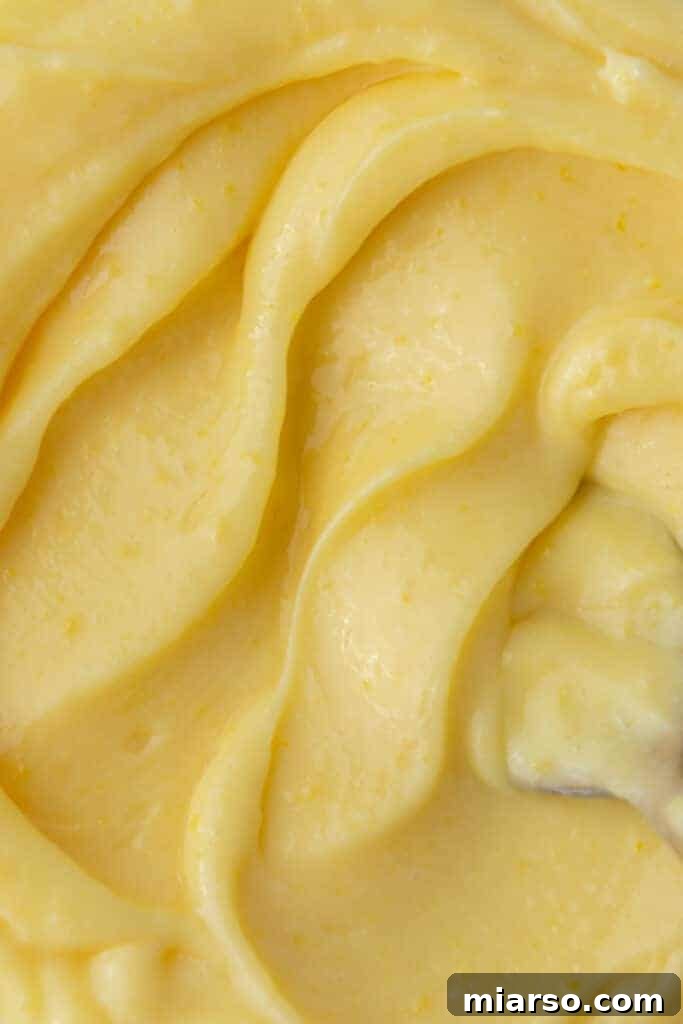 Microwave Magic: Luscious Lemon Curd in Minutes 12 Close-up overhead shot of the smooth, rich texture of microwave lemon curd in a jar.