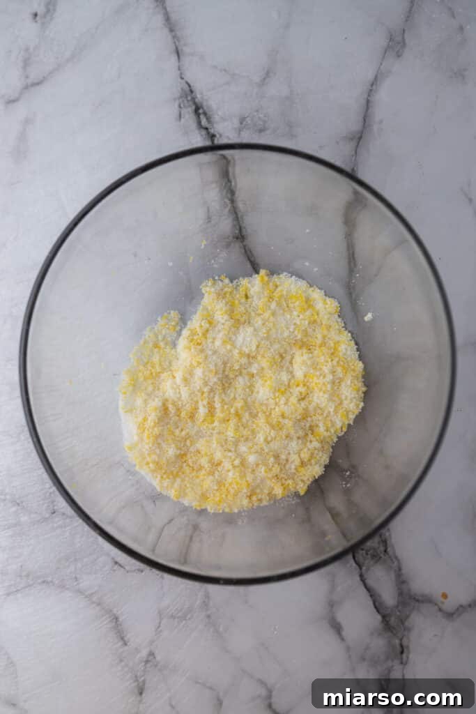 Microwave Magic: Luscious Lemon Curd in Minutes 5 Unmixed sugar and lemon zest in a bowl, showing the initial stage of the lemon curd recipe.