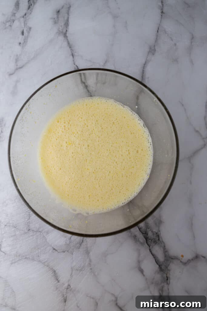 Microwave Magic: Luscious Lemon Curd in Minutes 6 Liquid ingredients (lemon juice and eggs) added to sugar and zest, ready for whisking.