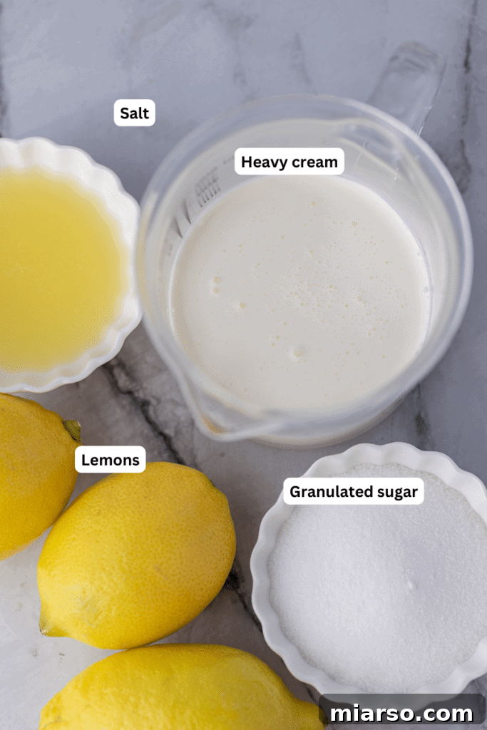 Fresh ingredients for an easy lemon posset recipe including heavy cream, granulated sugar, lemons, and lemon zest.
