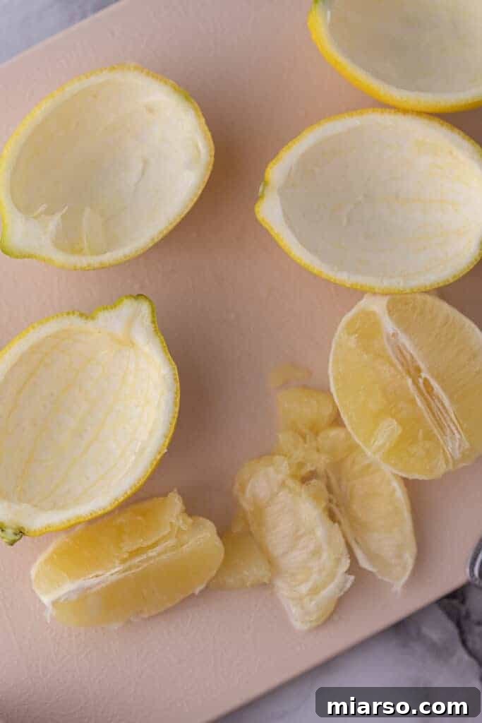 Emptied out lemon citrus shells, prepared for filling with posset mixture.