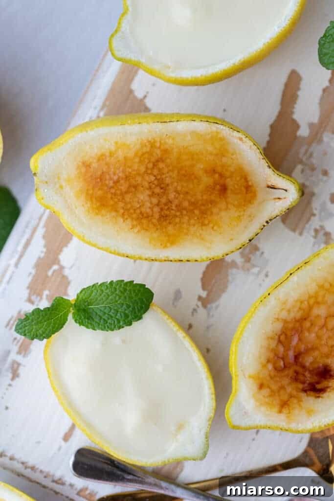 An easy lemon posset recipe served in lemon halves, with one brûléed for a caramelized top.