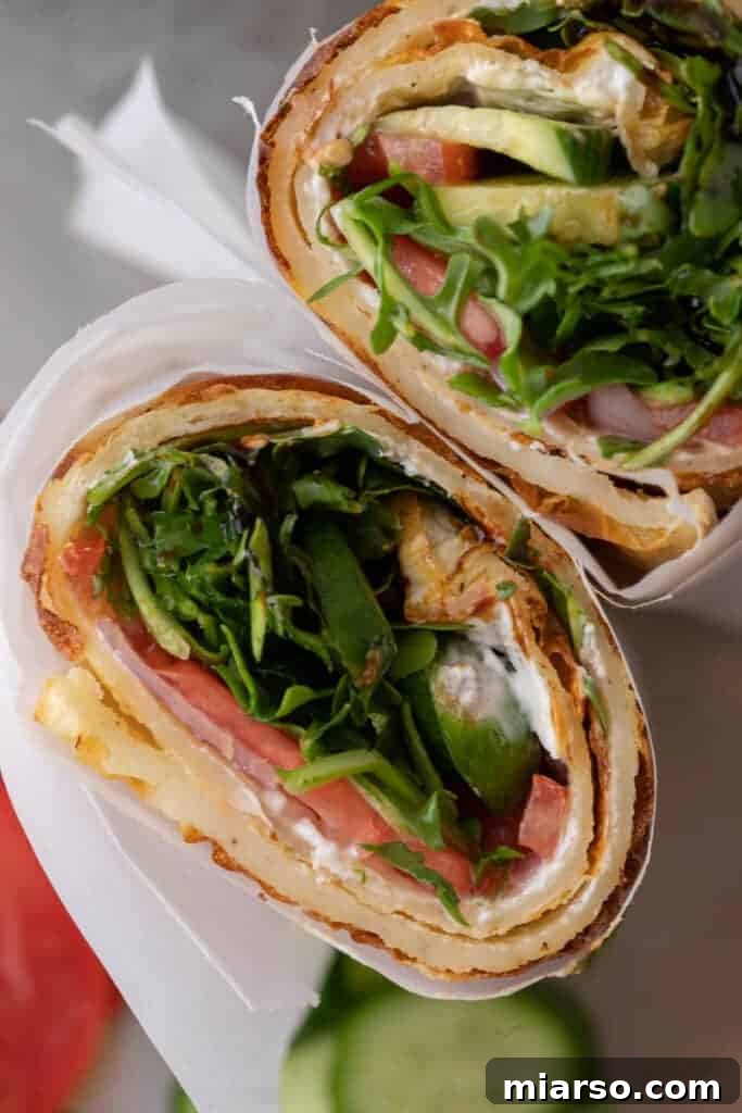 Overhead shot of a viral TikTok cottage cheese wrap filled with fresh veggies, spreadable cheese, and a drizzle of olive oil, ready to be enjoyed.