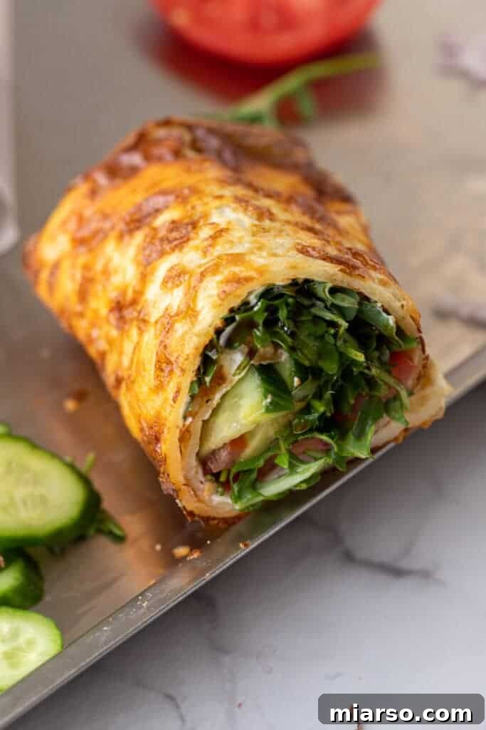 Half of a cottage cheese wrap sandwich, showing the flexible wrap and a delicious filling of fresh greens and cheese.