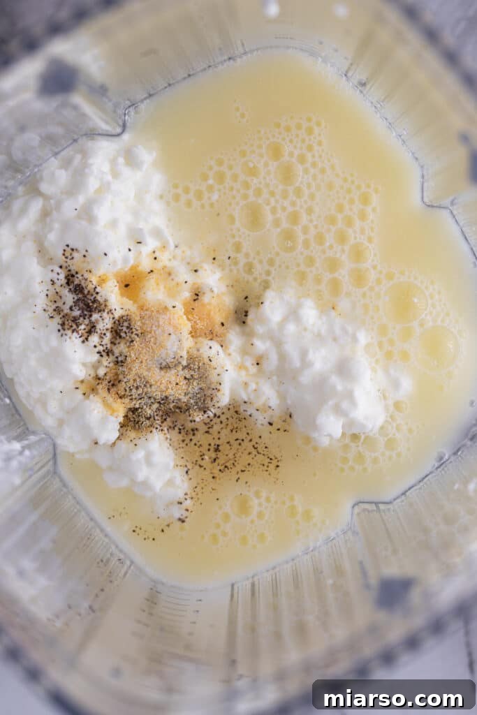 Wet ingredients (cottage cheese, egg whites, spices) in a blender, ready to be processed for the high-protein wrap.