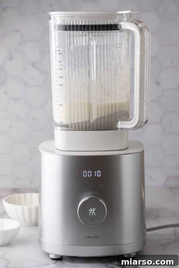 Close-up of the blended wet ingredients in a blender, showing a smooth, creamy texture perfect for the cottage cheese wrap.