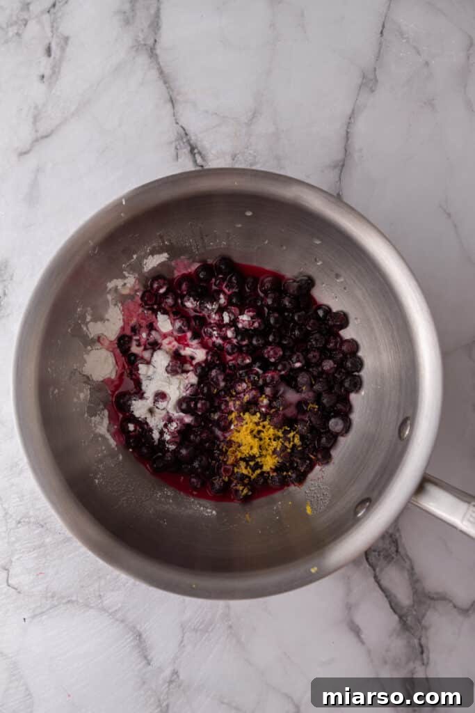 Unmixed blueberry topping ingredients in a pot