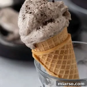 side shot of the ninja creami cookies and cream recipe on a cone
