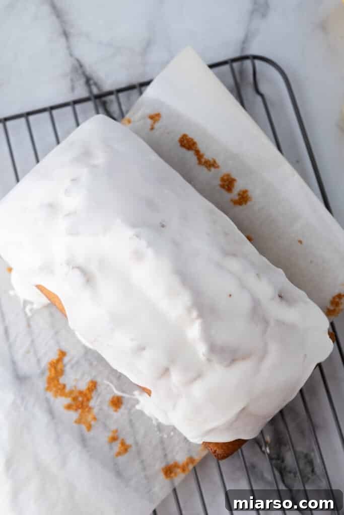 Overhead shot of the glazed Whole Lemon Blender Cake on a white platter