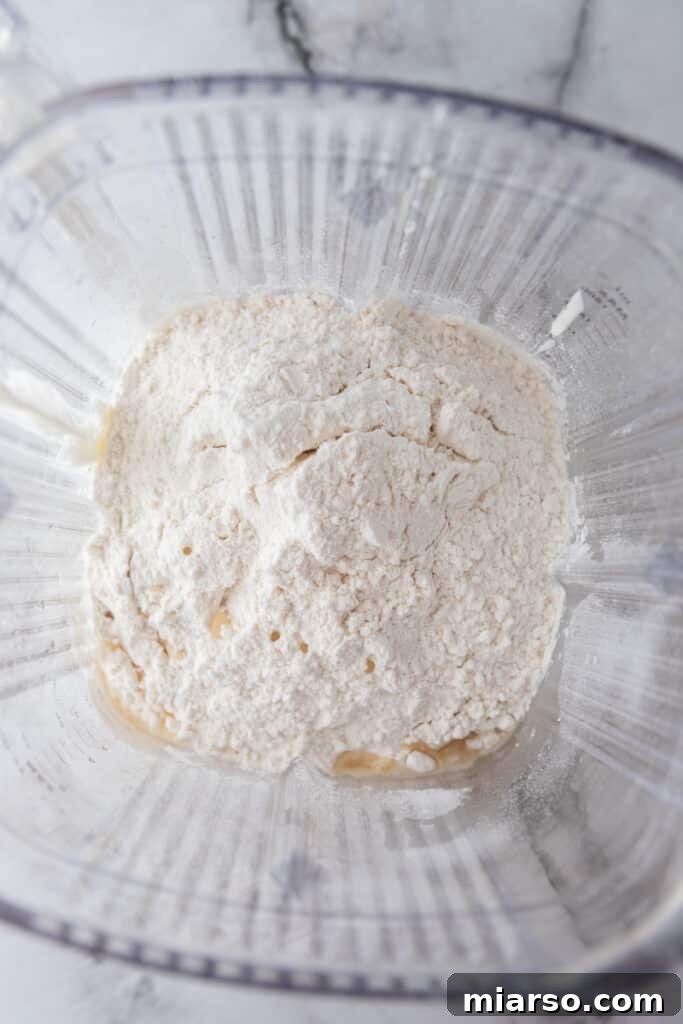 Close-up of unblended dry ingredients mixed with wet ingredients in a blender