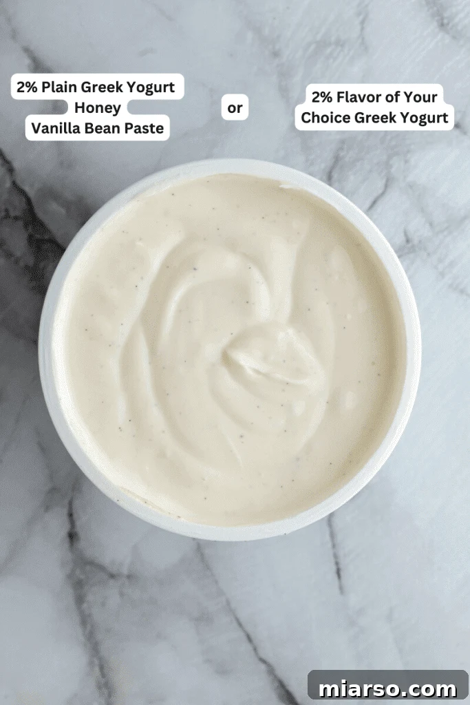Fresh ingredients laid out for Ninja Creami frozen yogurt, including Greek yogurt, honey, and vanilla extract.