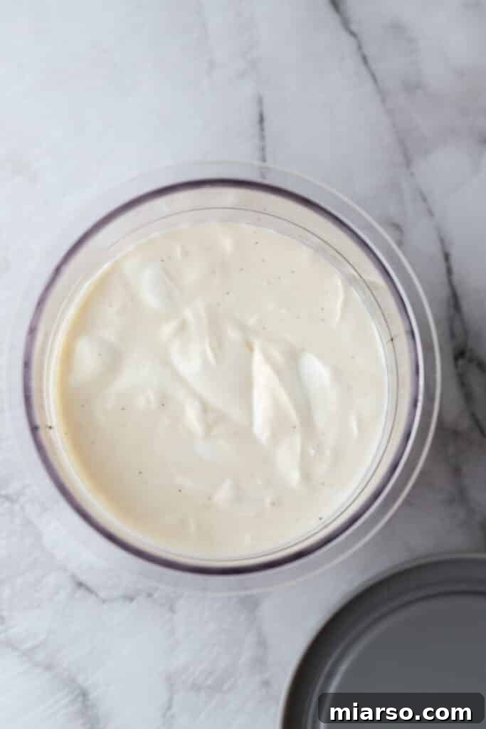 Ninja Creami pint cup with fresh yogurt mixture before freezing.