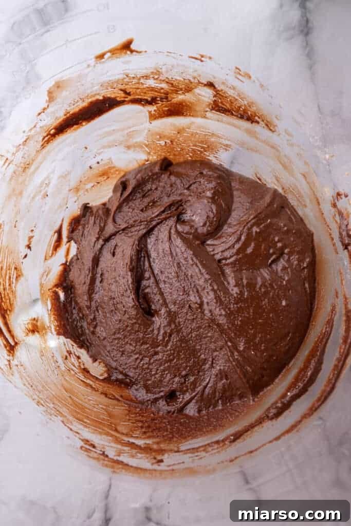 Rich chocolate cookie dough in a mixing bowl.