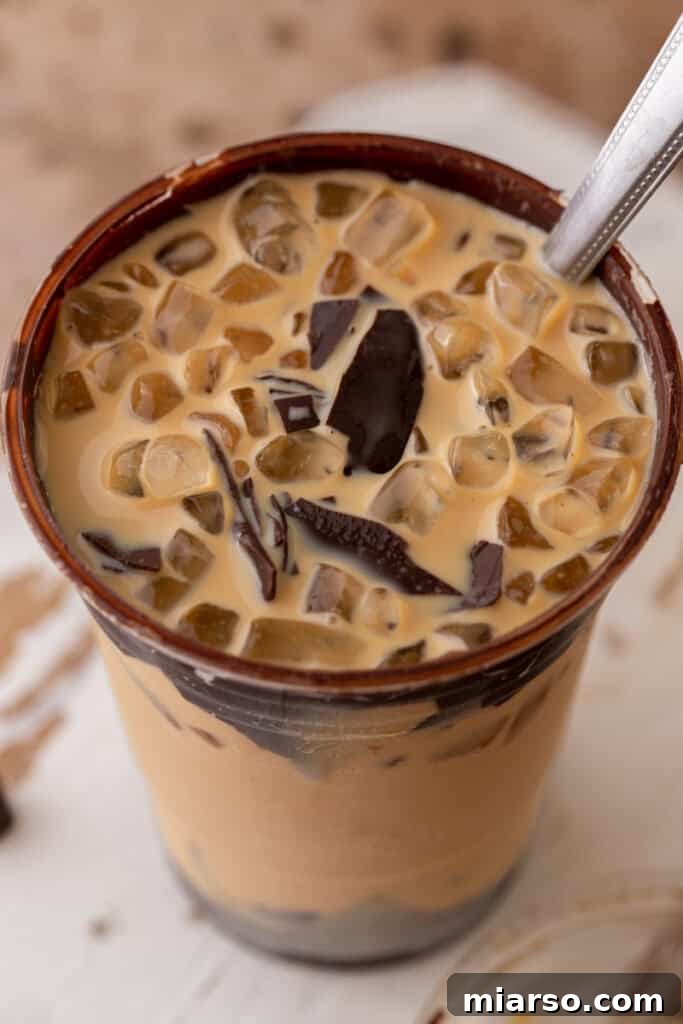 Overhead view of cracking latte with ice nuggets