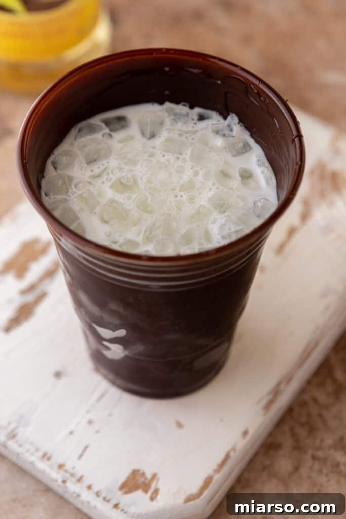 Milk and ice in chocolate cup