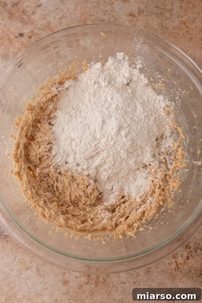 Perfect No Bake Chocolate Chip Cookie Dough 7 Wet ingredients and flour in a bowl
