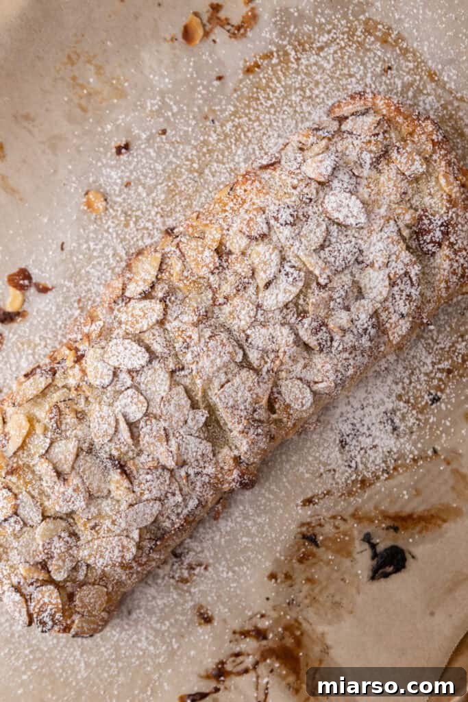 Baked almond danish with powdered sugar dusting