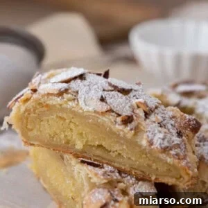Two pieces of Braided Almond Croissant Danish stacked on top of each other