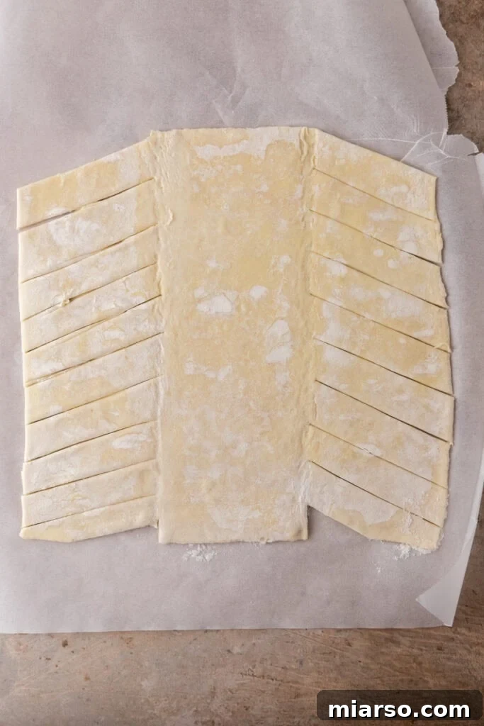 Puff pastry sheet unrolled and cut into strips for braiding
