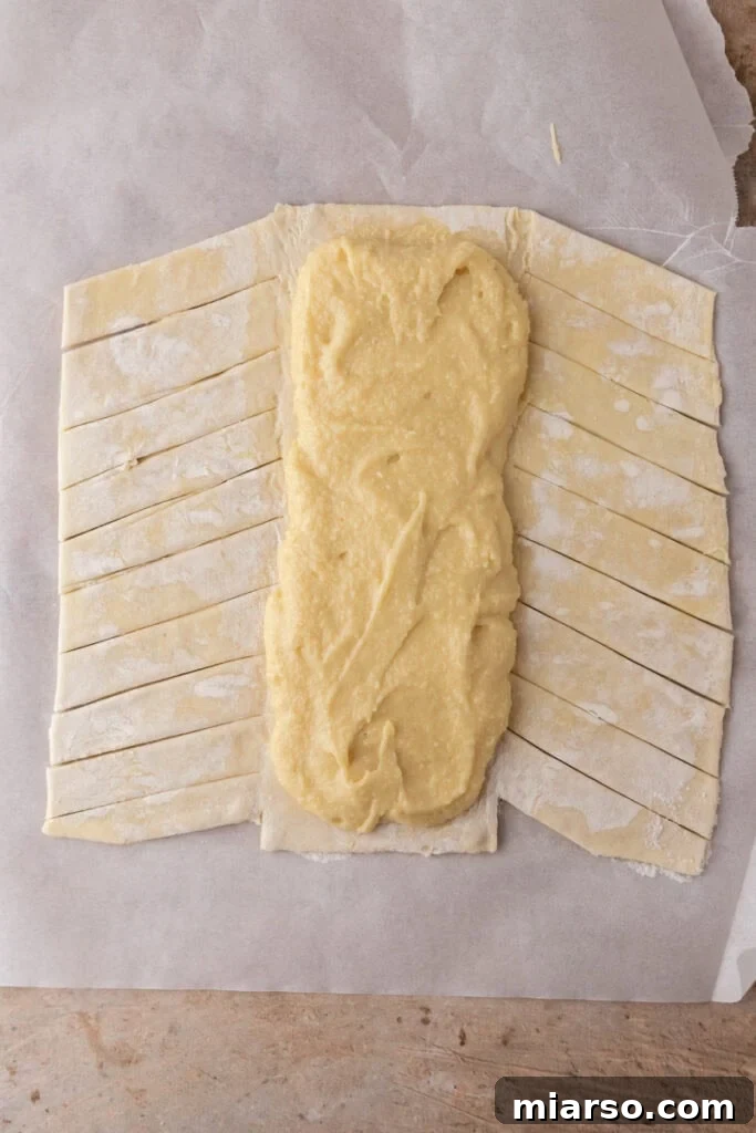 Puff pastry with frangipane filling spread down the center