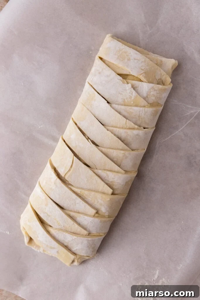 Puff pastry strips braided over the frangipane filling