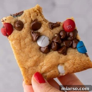 Hand holding patriotic sheet pan red white and blue M&M's cookie bars