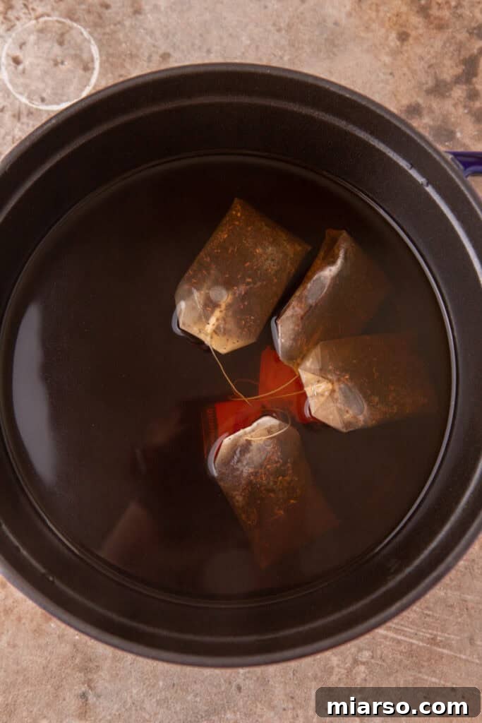 tea bags steeping in a pot of hot water for iced tea