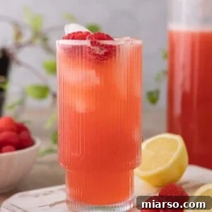 A refreshing glass of homemade raspberry lemonade with ice