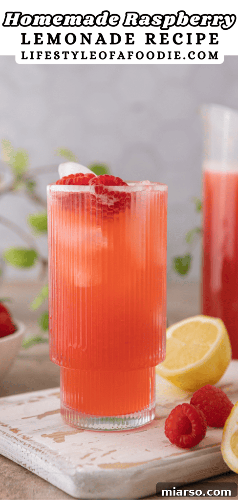 Pinterest pin featuring a pitcher of homemade raspberry lemonade
