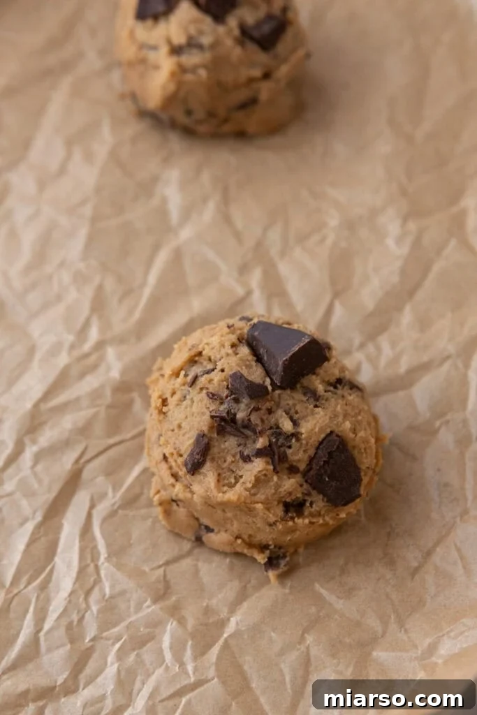 Cookie dough ball on parchment paper