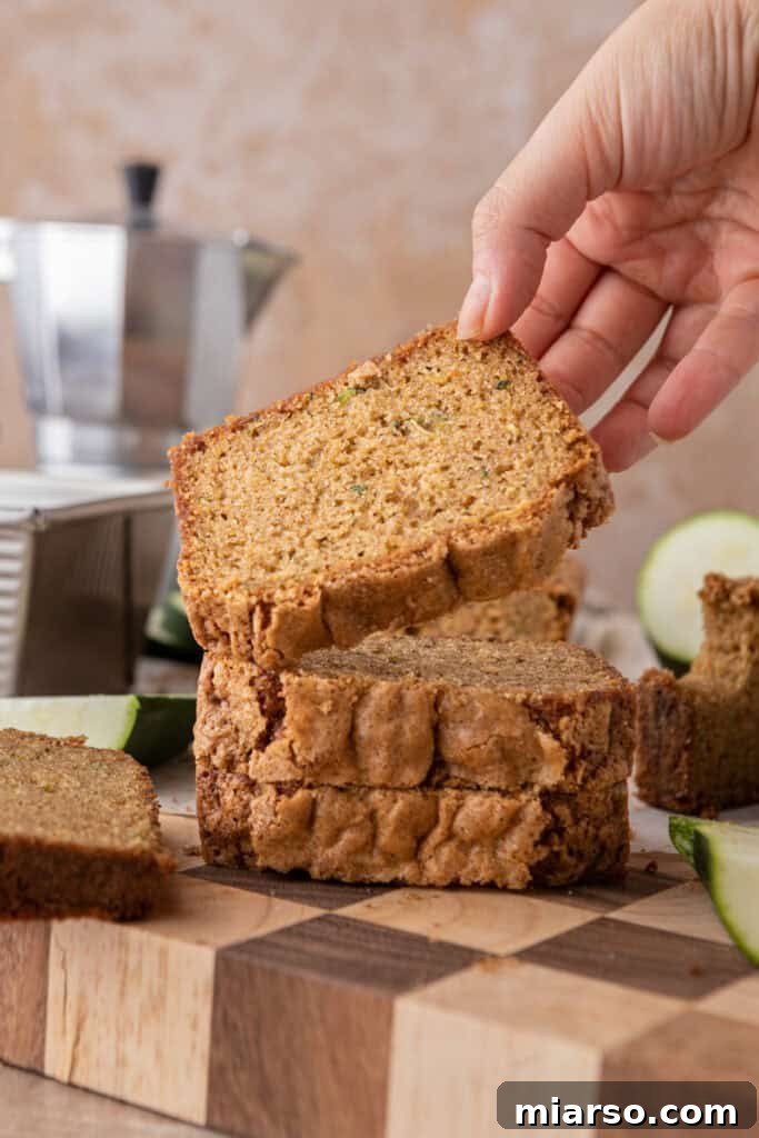 a slice of zucchini bread recipe getting picked up by a hand