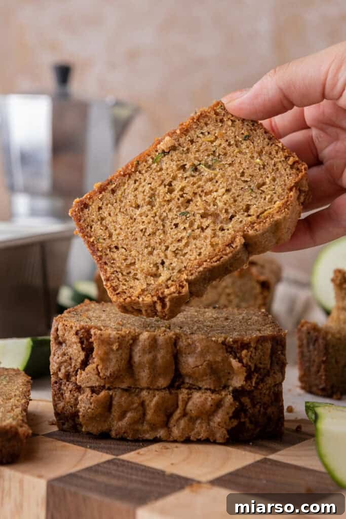 a slice of zucchini bread recipe getting picked up by a hand
