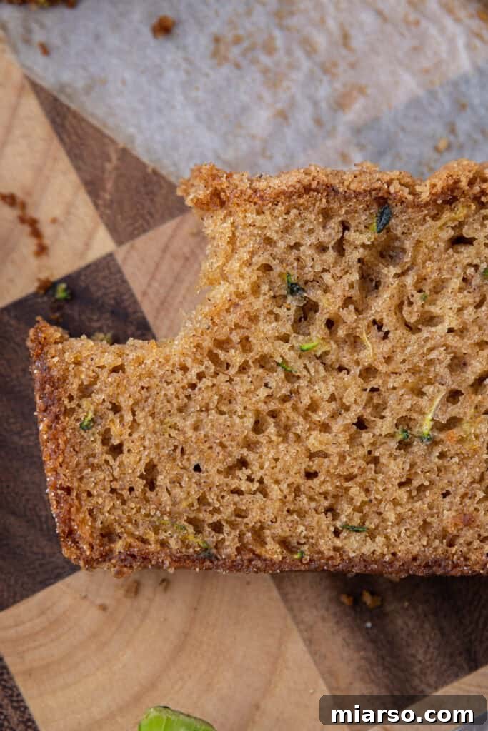 overhead close up of a slice of zucchini bread recipe with a bite taken out
