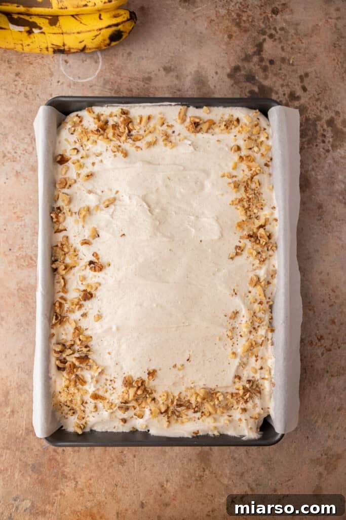 Simply Irresistible Banana Cake 12 Overhead shot of a frosted banana cake in a pan