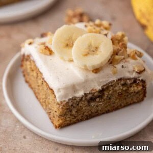 Simply Irresistible Banana Cake 17 A slice of the ultimate banana cake with cream cheese frosting on a plate