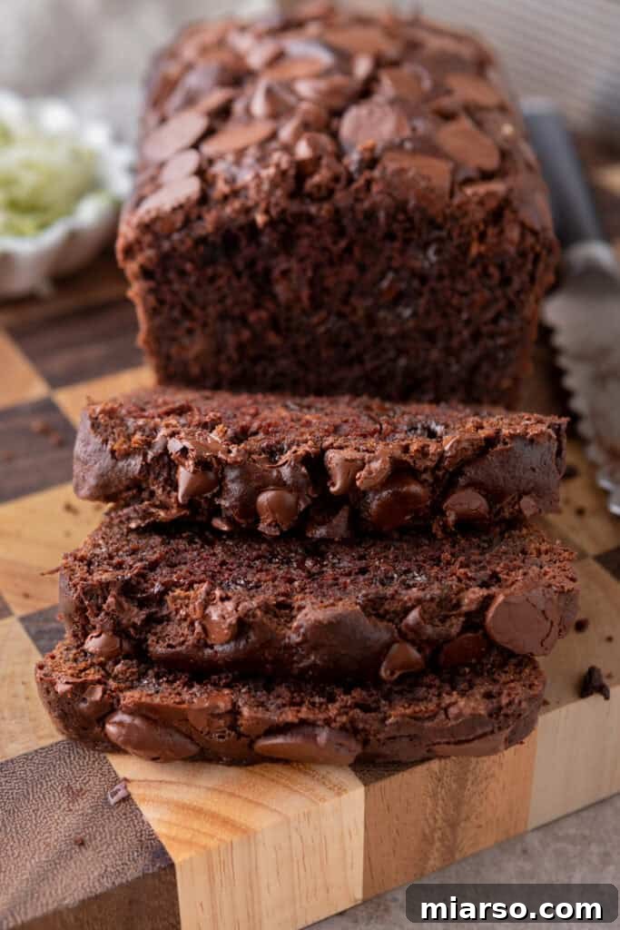 Decadent Double Chocolate Zucchini Loaf 2 Slices of moist Double Chocolate Zucchini Bread with visible chocolate chunks, ready to be enjoyed