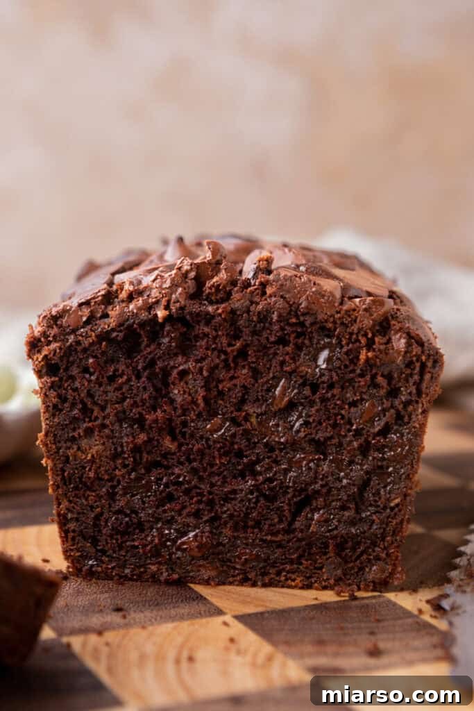 Decadent Double Chocolate Zucchini Loaf 11 A delicious side profile shot of a slice of Double Chocolate Zucchini Bread, highlighting its moist texture