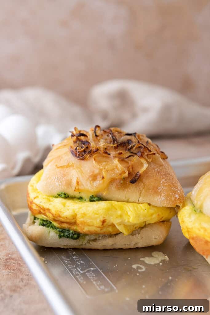 Two Starbucks Egg Kale Pesto Mozzarella Sandwich copycat recipes arranged beautifully on a plate, garnished with fresh herbs, ready to be served.