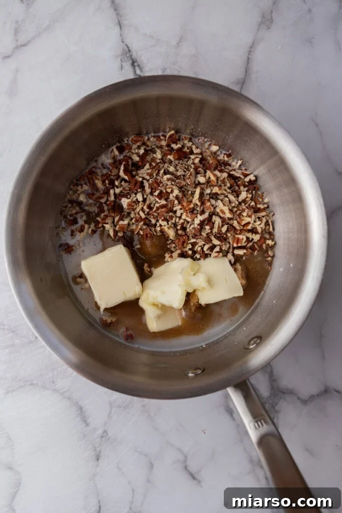 Close-up of all raw ingredients for New Orleans Pralines gathered in a metal pot, ready for cooking.