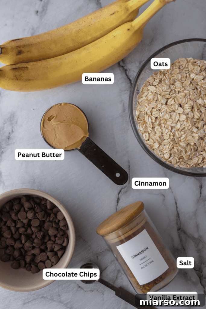 Wholesome Banana Oat Cookies 3 All the healthy oatmeal banana cookie recipe ingredients laid out on a clean surface
