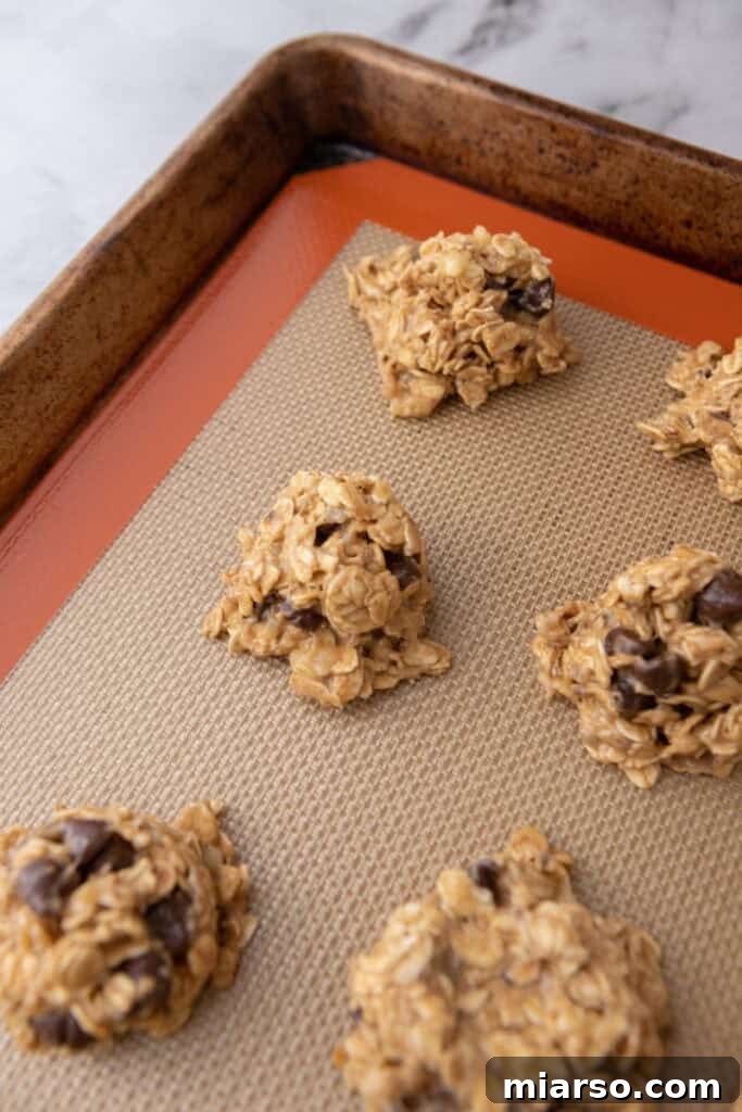 Wholesome Banana Oat Cookies 8 Balls of cookie dough on a baking sheet, ready to be flattened