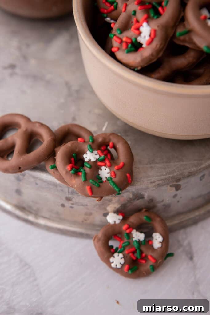 Sweet and Salty Chocolate Pretzel Delight 4 Several chocolate-covered pretzel twists scattered, some with sprinkles, ready to be enjoyed.