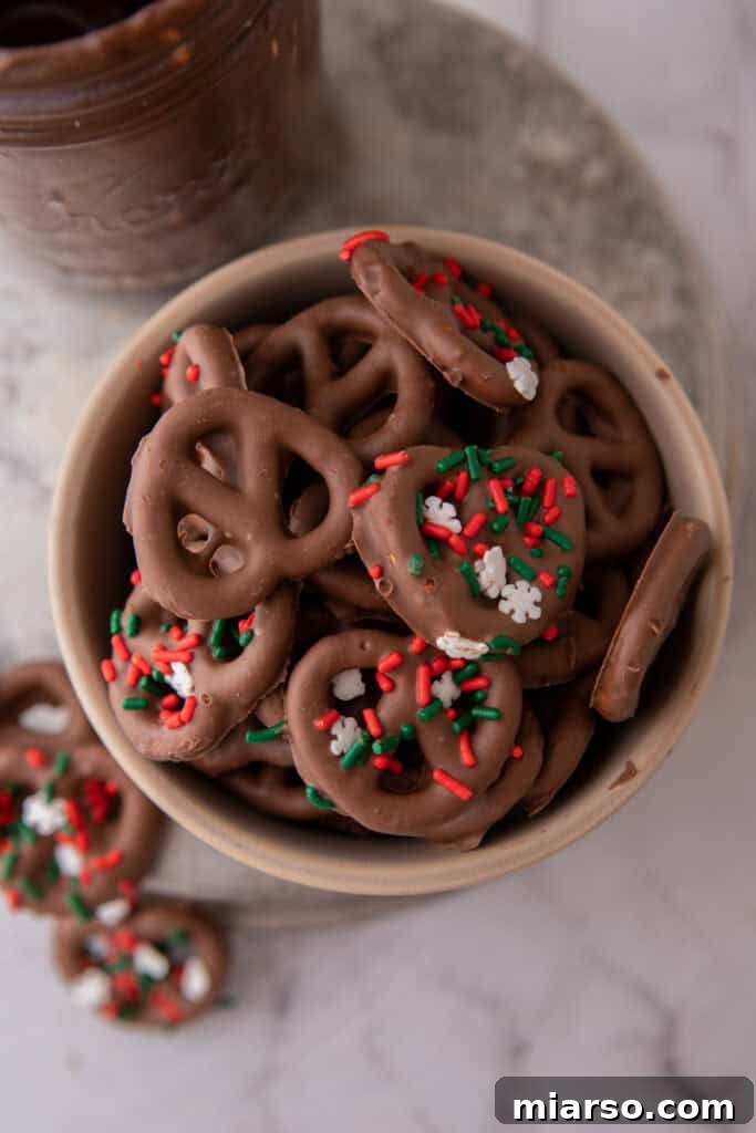 Sweet and Salty Chocolate Pretzel Delight 10 A bowl of chocolate-covered pretzels with colorful sprinkles, emphasizing their appealing presentation.