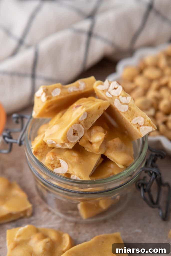 More pieces of microwave peanut brittle in a jar, showcasing its attractive appearance.