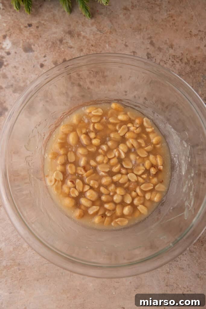 Butter, peanuts, and vanilla stirred into the sugar mixture.
